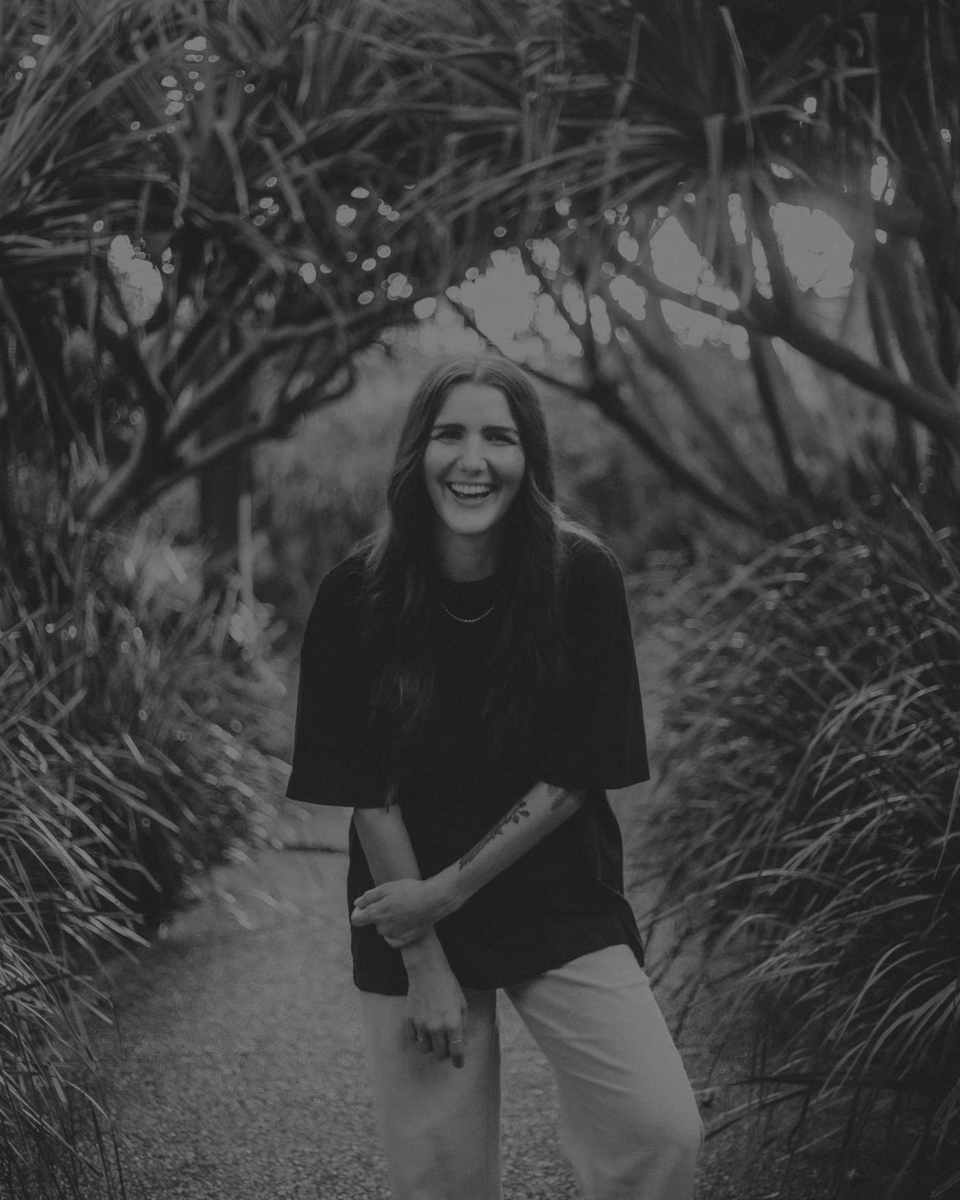 Jayde Baker laughing on a garden path
